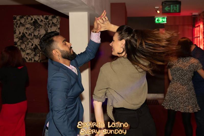 Sultan spins his partner in salsa dance