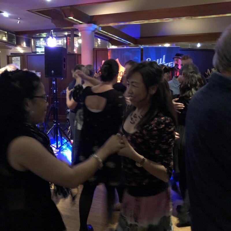 two ladies spinning on dance floor